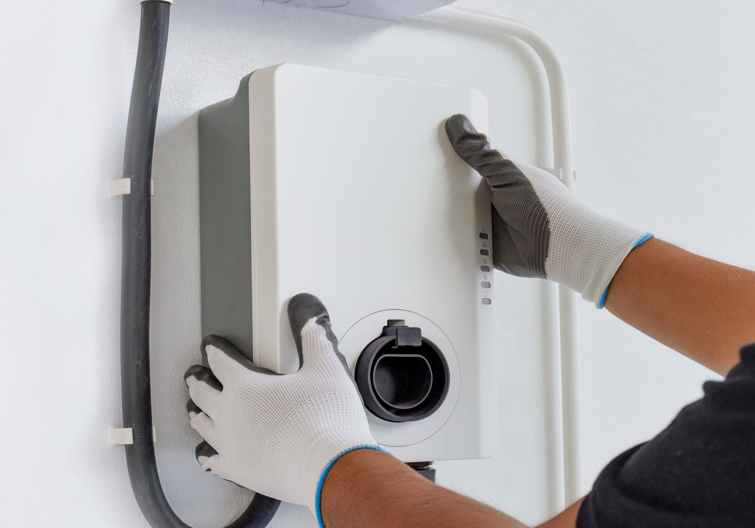 Certified male Electrician Installing Home EV Charger